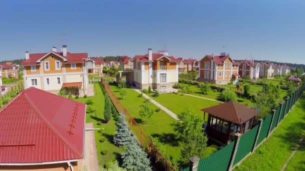 Cottage town near forest at sunny summer day. Aerial view — Stock Video