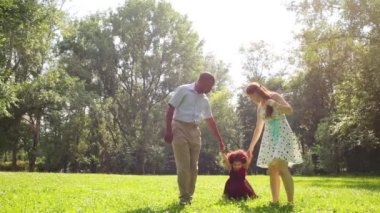 Mutlu anne ile küçük kızları parkta yürüyüş