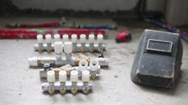 Plumbing vents, level tool on the floor and heating radiator