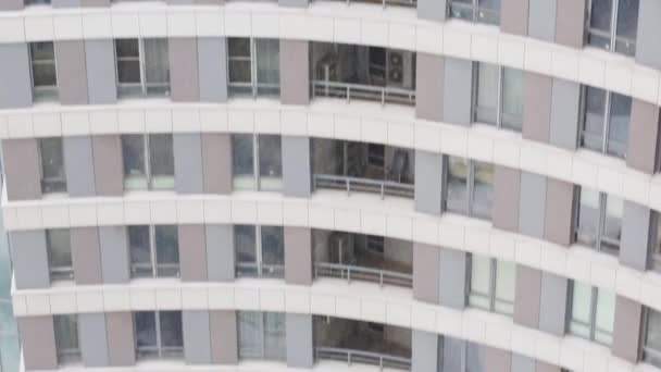 Parete di alto edificio con molte finestre durante la nevicata — Video Stock