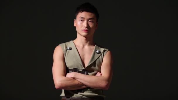 Handsome young asian man in costume poses in studio — Stock Video