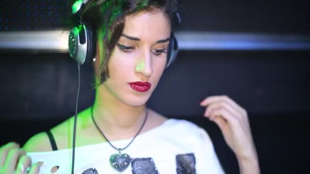 Ansikte DJ kvinna dansa bakom maskinen i nattklubb — Stockvideo