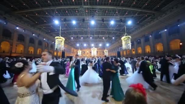 Разные пары кружатся в танце под фиолетовыми огнями — стоковое видео
