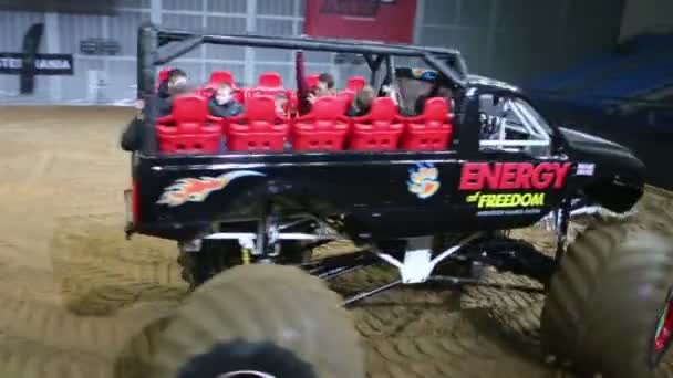 People ride on a giant passenger offroader on sports show — Stock Video