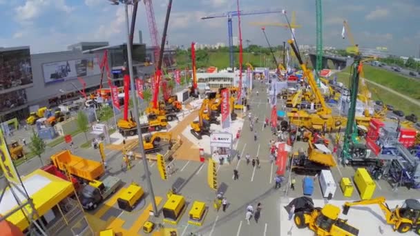Visitors watch machines on territory of Specialized Exhibition — Stock Video