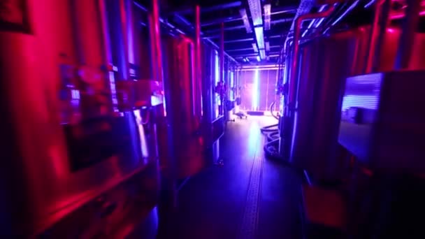 Moving between rows of steel tanks at microbrewery. — Stock Video