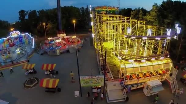 Amusements area with people in park of VDNH at spring evening — Stock Video