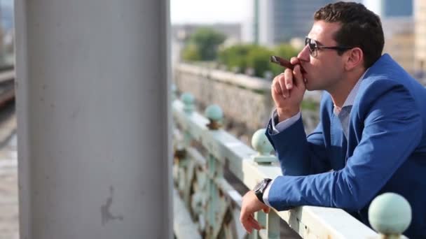 Young man smokes cigar — Stock Video