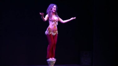 Young woman in eastern dress dances 