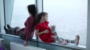 Kadın ve kız pencere kenarında oturmak