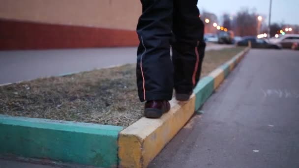 Legs of girl walking on border — Stock Video