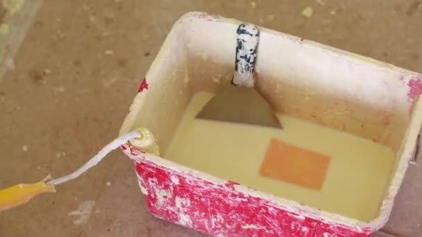 Red bucket with roller brush and pallet — Stock Video