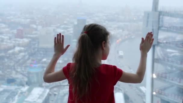 Back of little girl touching window — Stock Video