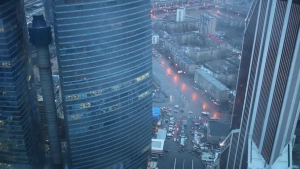 Modern skyscrapers in evening city and road. — Stock Video