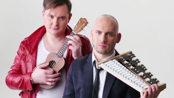 Två unga män med musikinstrument — Stockvideo