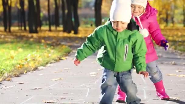 Zwei Kinder spielen Hopscotch — Stockvideo