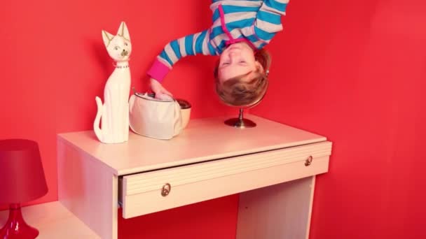 Little girl upside down in bedroom — Stock Video