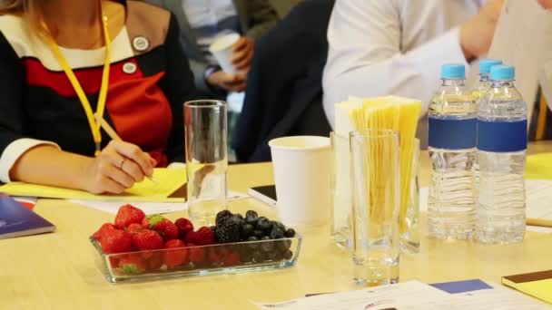 Berries, bottles with water on table — Stock Video