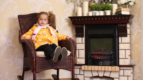 Menina senta-se na cadeira de balanço — Vídeo de Stock