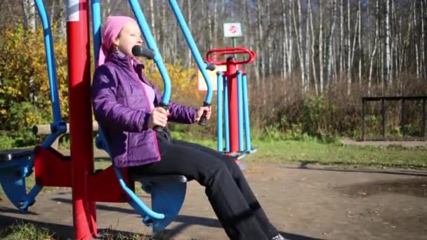 Frau macht Übungen am Simulator — Stockvideo