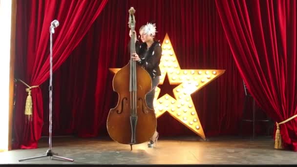 Woman plays contrabass and dances — Stock Video