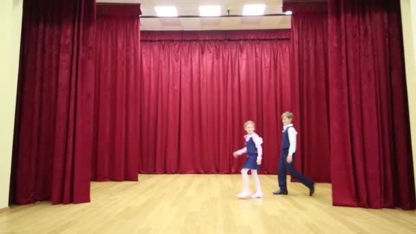 Girl and boy in uniforms enter stage — Stock Video