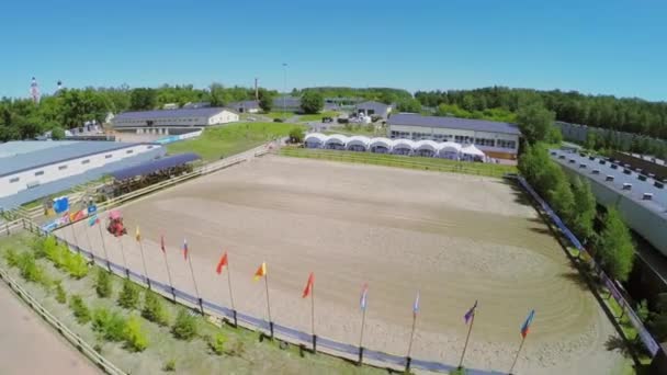 Tractor prepares sand on equestrian arena — Stock Video