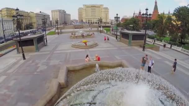 Les gens marchent près de la fontaine sur la place Manezhnaya — Video