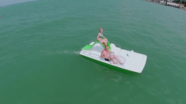 Woman with father ride on catamaran — Stock Video