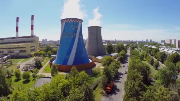 Cars ride by street near power plant — Stock Video