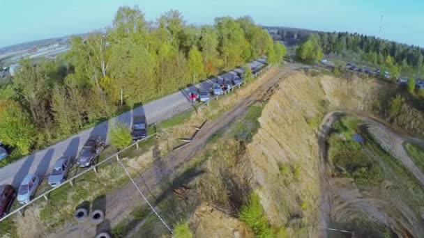 Coches aparcados cerca de pista de carreras — Vídeo de stock