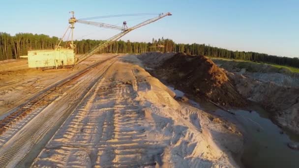 Excavator works at sandpit during sunset — Stock Video