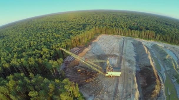 Forest around sandpit with excavator and bulldozers — Stock Video