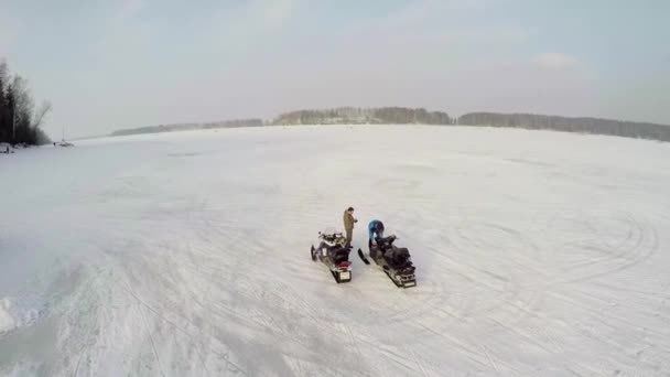 Twee mannen bereiden sneeuwscooters — Stockvideo