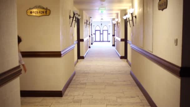 Girl in ethnic dress going in hallway — Stock Footage Girl in ethnic dress going in hallway Video Clip