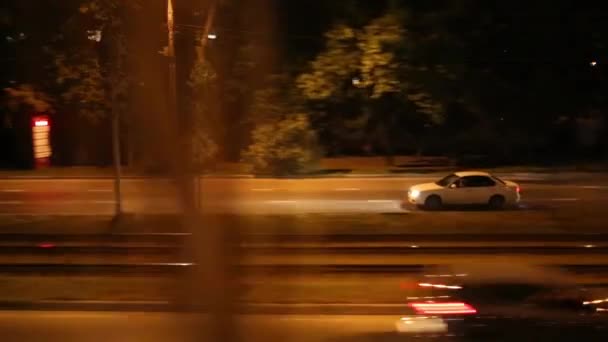 Cars moving near railway at night — Stock Video