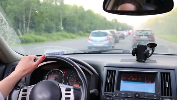 Woman driving car in traffic jam — Stock Video