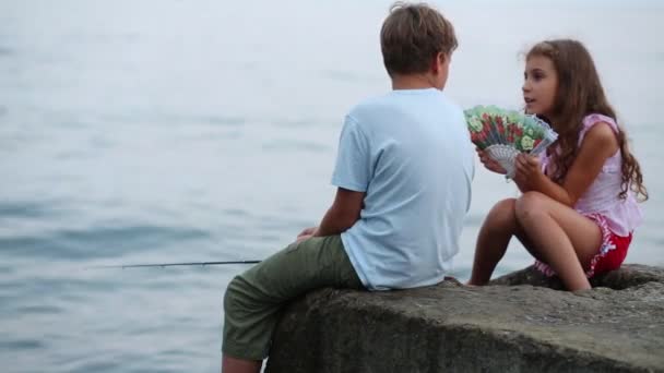 Chlapec s rybářský prut a dívka s ventilátorem — Stock video