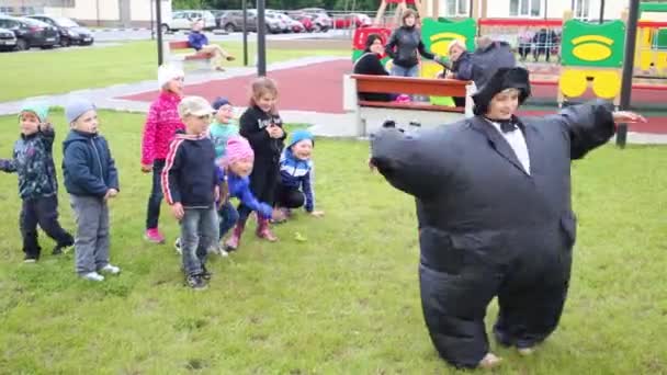 Girl in inflatable costume and kids — Stock Video