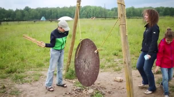 Mãe e crianças brincam com gong de metal — Vídeo de Stock