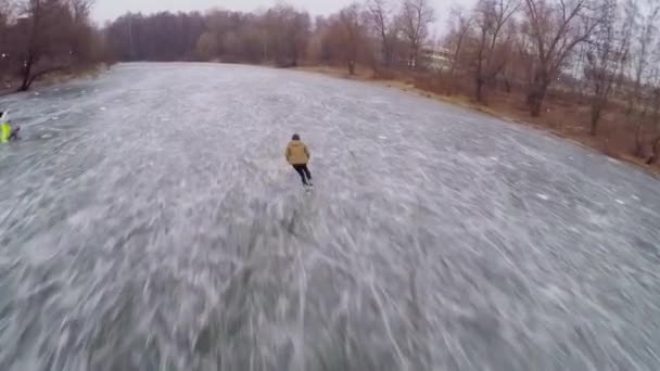 Young man skating on icy pond — Stockvideo