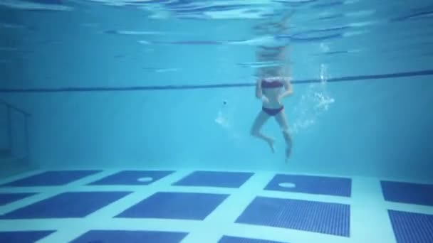 Flicka i glasögon simma under vattnet — Stockvideo