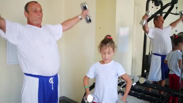 Grootvader en kleindochter treinen met dumbbells — Stockvideo