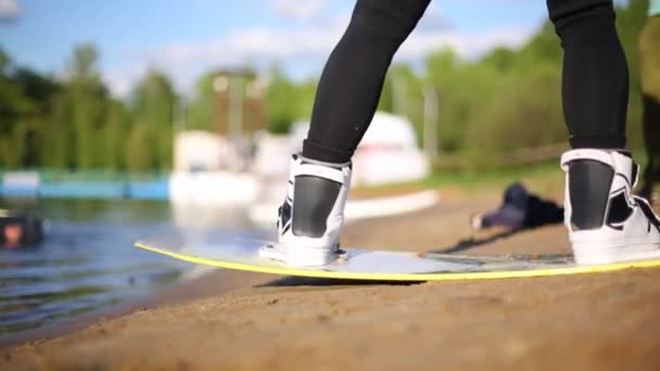 Legs of wakeboarder on board — Stock Video