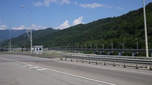 Movimiento por la carretera moderna entre montañas — Vídeo de stock