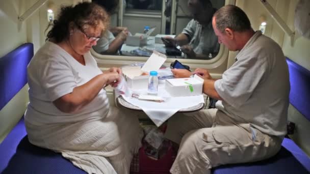 Man and woman sit in train. — Stock Video