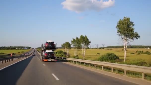 Cars and trucks move on rural road — Stock Video