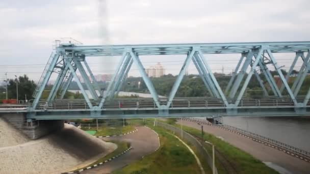 Cityscape and view of bridge from train window — Stock Video