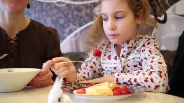 Kleine schöne Mädchen essen Pfannkuchen — Stockvideo