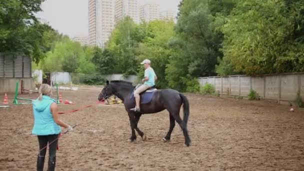 Boy and woman ride on horsebacks — Stock Video